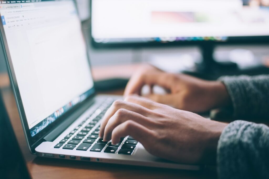 Business professional using a laptop illustrating business email compromise in freight