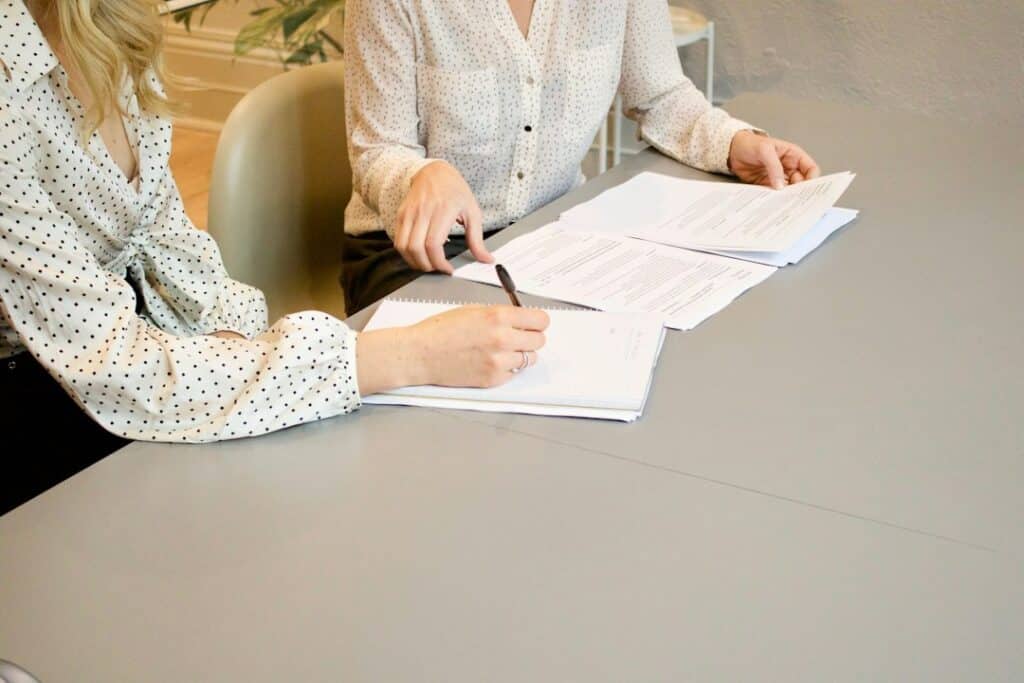 Business professionals reviewing financial documents for freight broker bond compliance