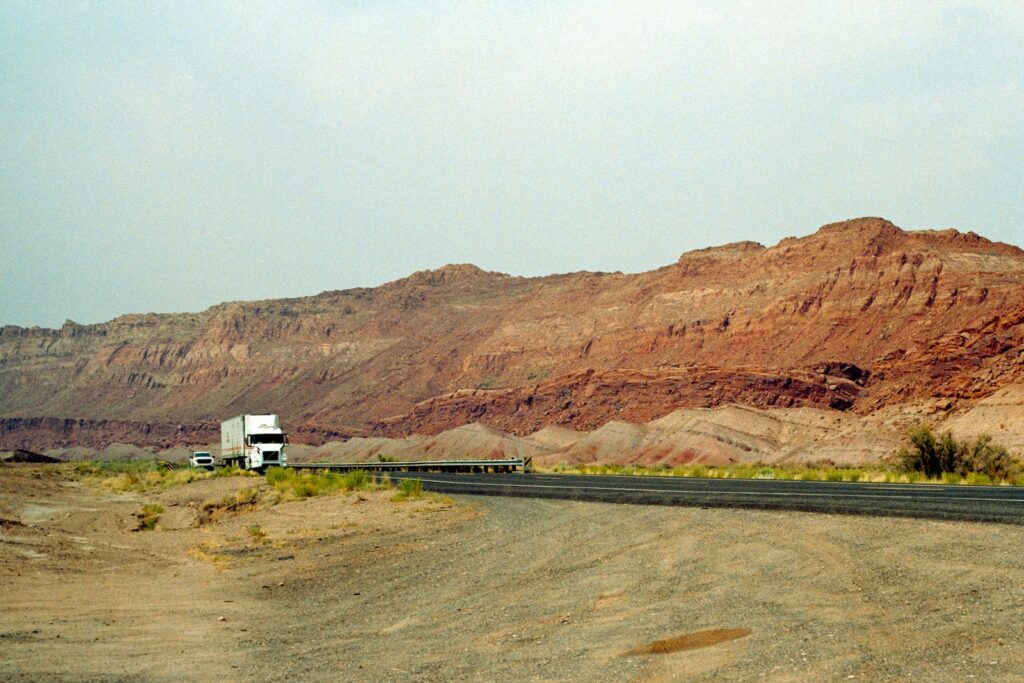 Truck traveling through rocky desert hills in Arizona