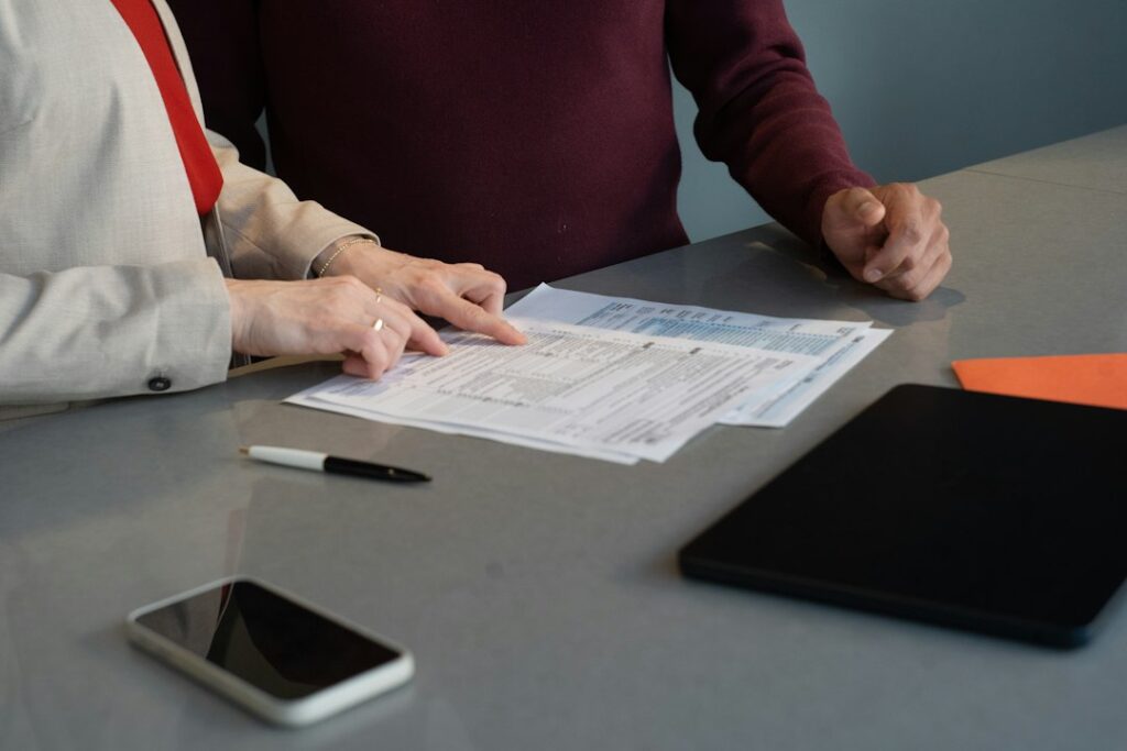 Two business professionals reviewing paperwork at a desk