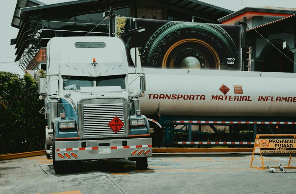 Semi truck parked beside heavy industrial equipment